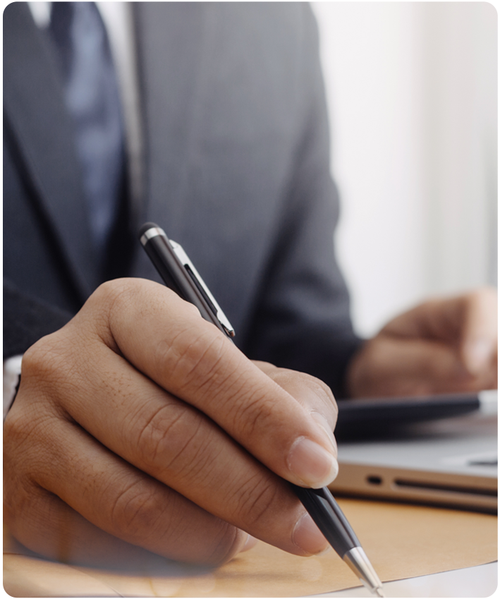 Medical Malpractice Case Closeup of hand holding pen while writing malpractice case notes