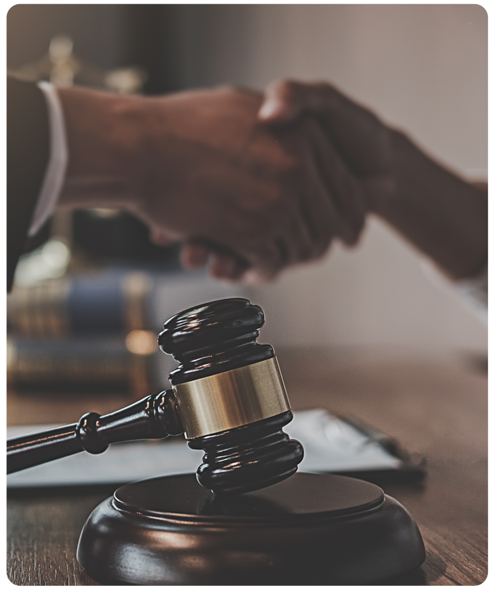 Lawyer and Client shaking hands with gave in foreground